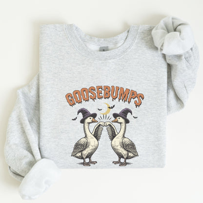 Halloween sweatshirt with two geese in witch hats bumping wings under a crescent moon — spooky and fun fall apparel.