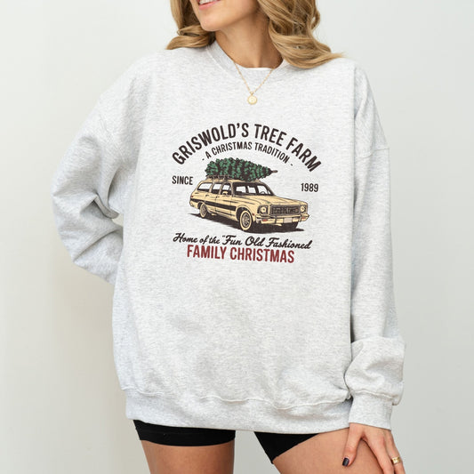 Griswold's Tree Farm holiday sweatshirt with vintage Christmas design featuring a family car carrying a Christmas tree.