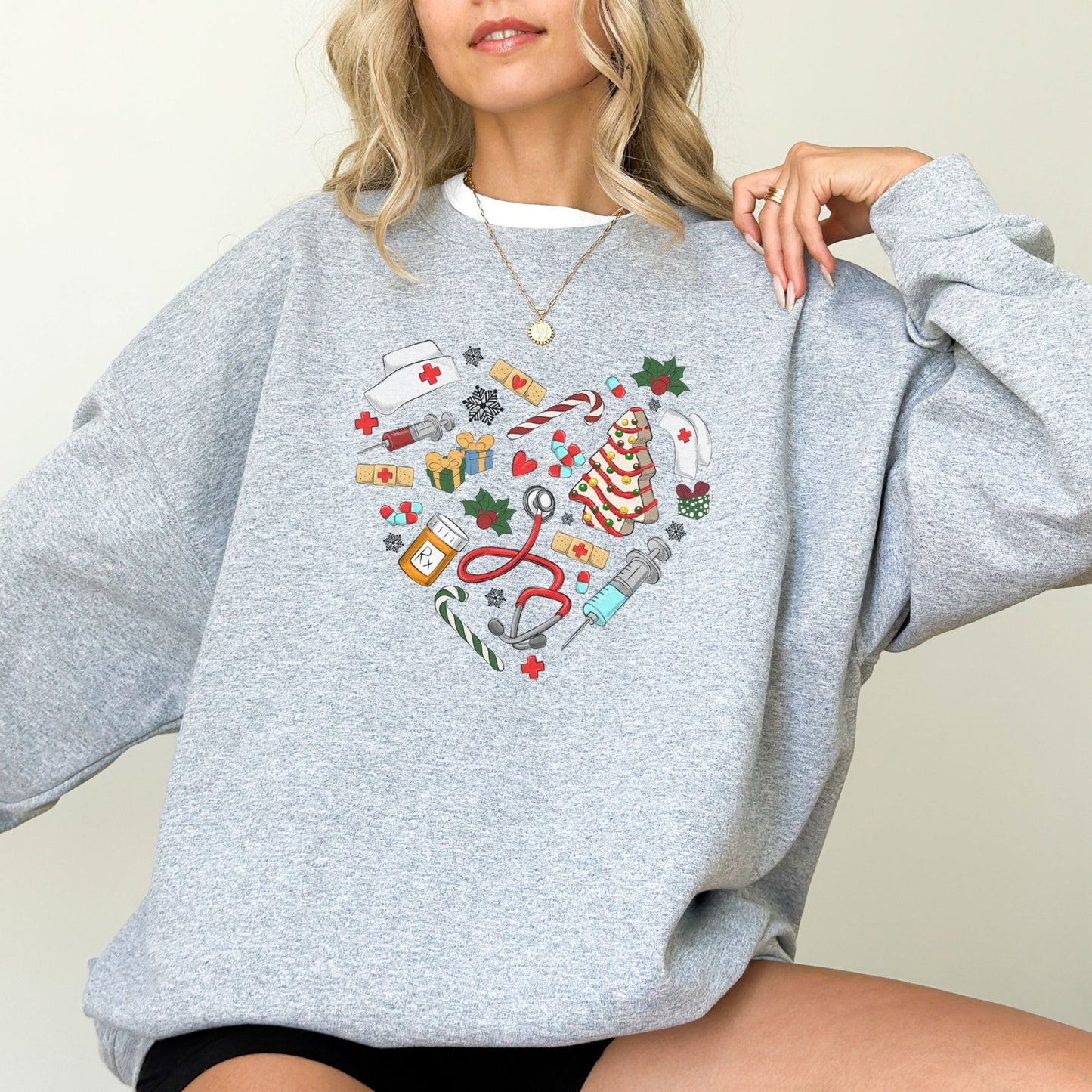 Nurse Christmas sweatshirt with holiday-themed medical icons in a heart shape.