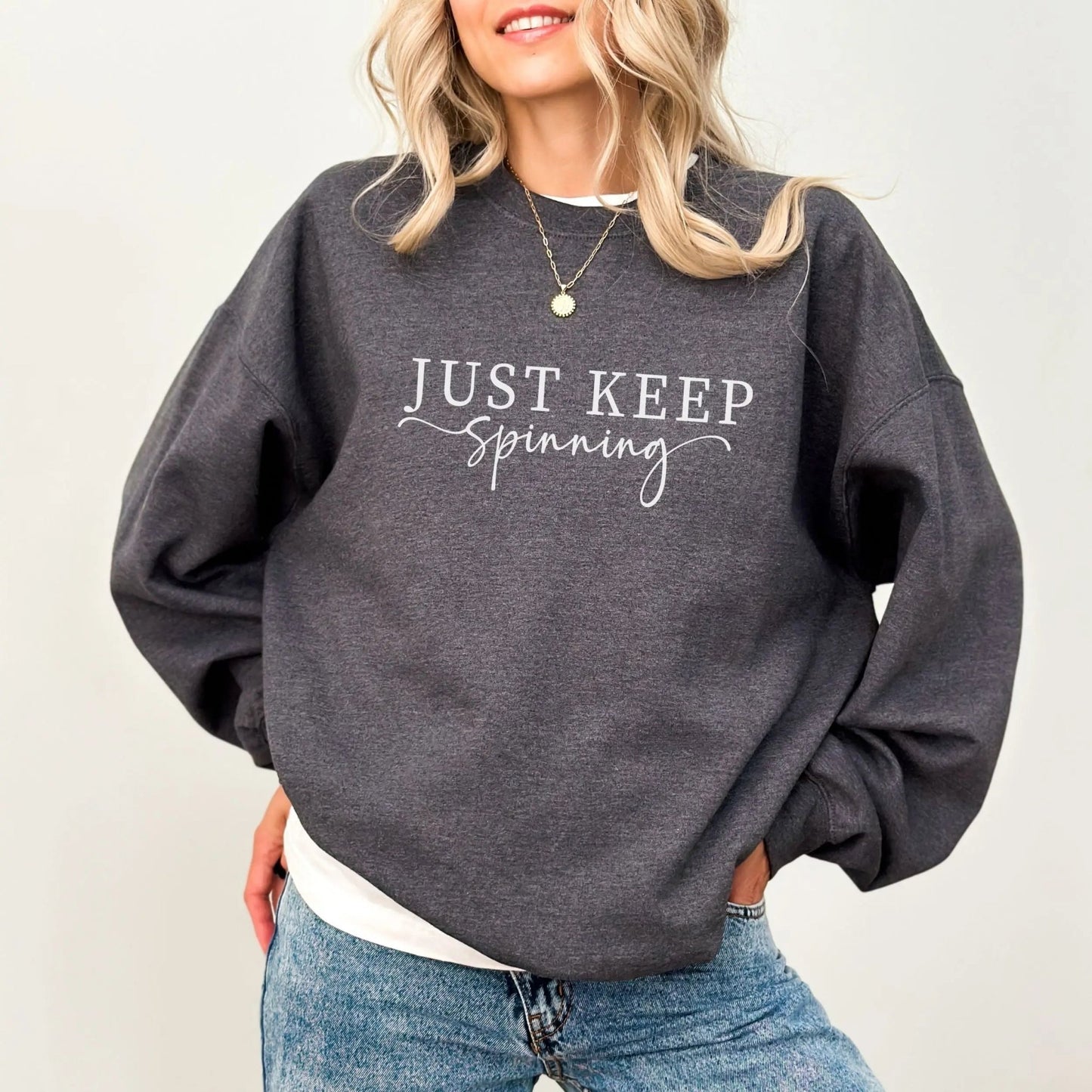 "Just Keep Spinning" sweatshirt from That Cozy Vibe, perfect for fitness and motivation.