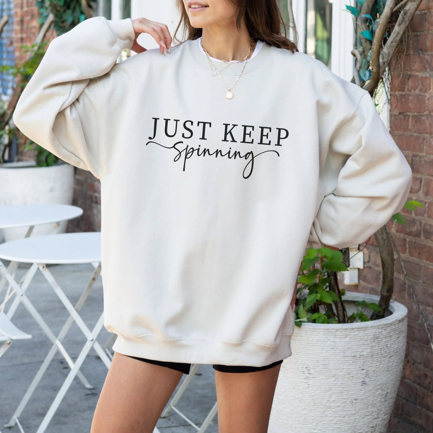 "Just Keep Spinning" sweatshirt from That Cozy Vibe, perfect for fitness and motivation.