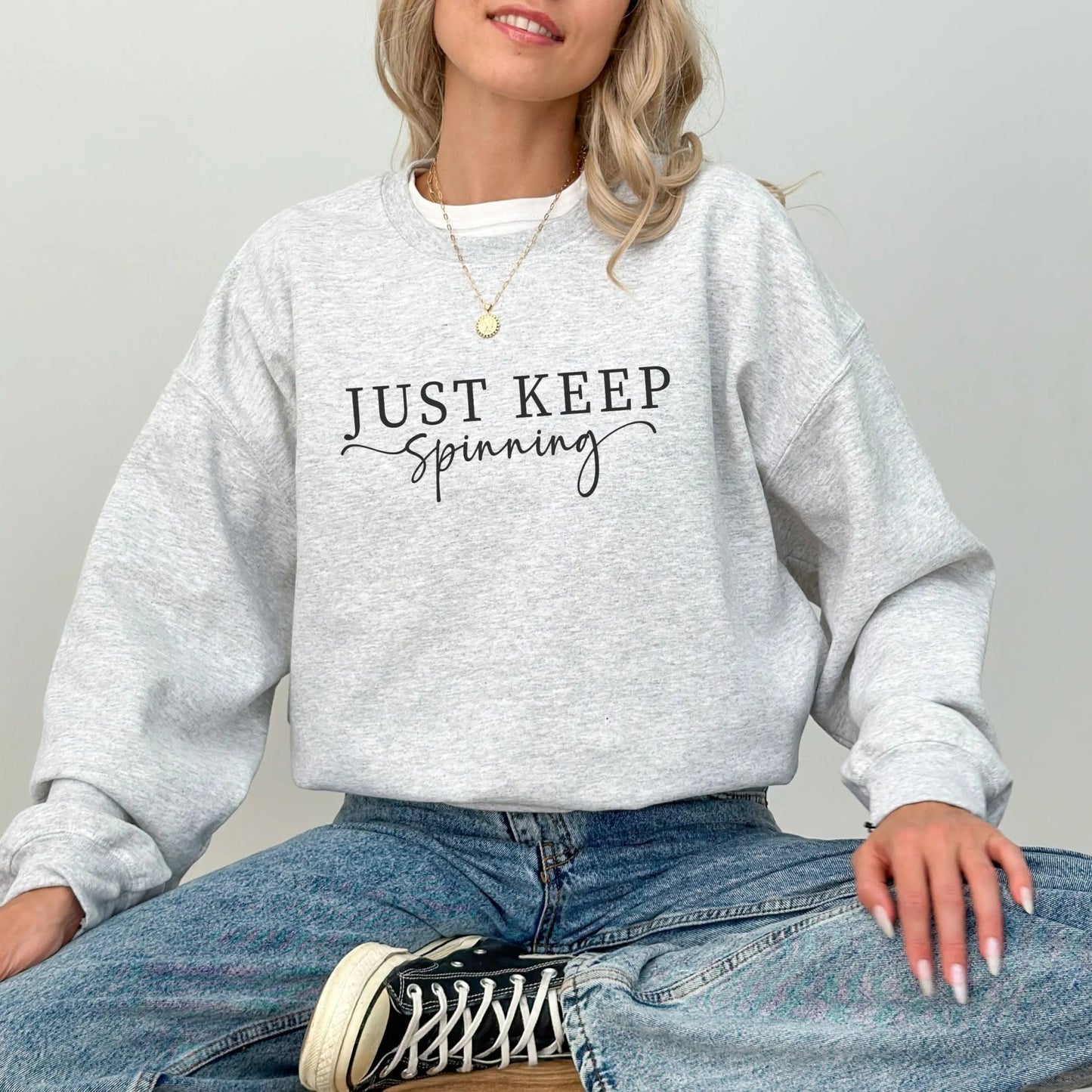 "Just Keep Spinning" sweatshirt from That Cozy Vibe, perfect for fitness and motivation.