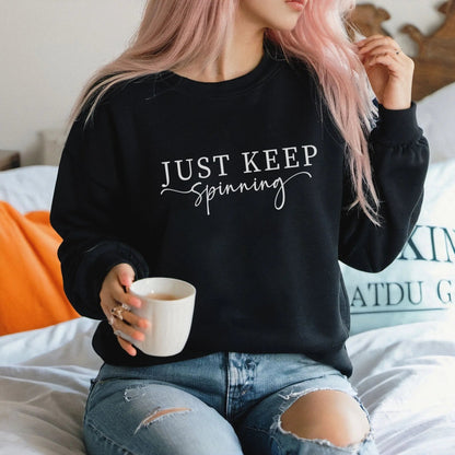 "Just Keep Spinning" sweatshirt from That Cozy Vibe, perfect for fitness and motivation.