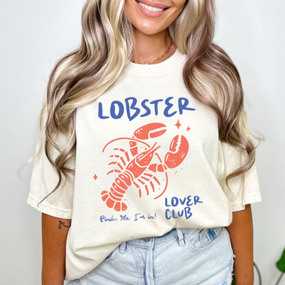 Colorful cartoon lobster with the phrase "Lobster Lover Club – Pinch Me, I'm In!" on a fun summer t-shirt for seafood and beach lovers.