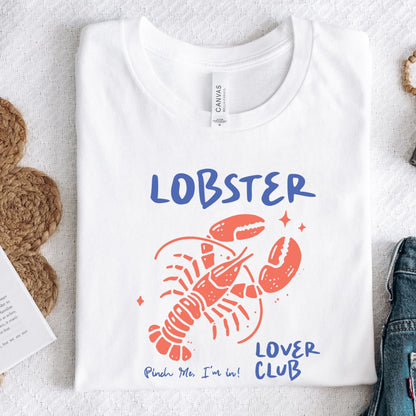 Colorful cartoon lobster with the phrase "Lobster Lover Club – Pinch Me, I'm In!" on a fun summer t-shirt for seafood and beach lovers.