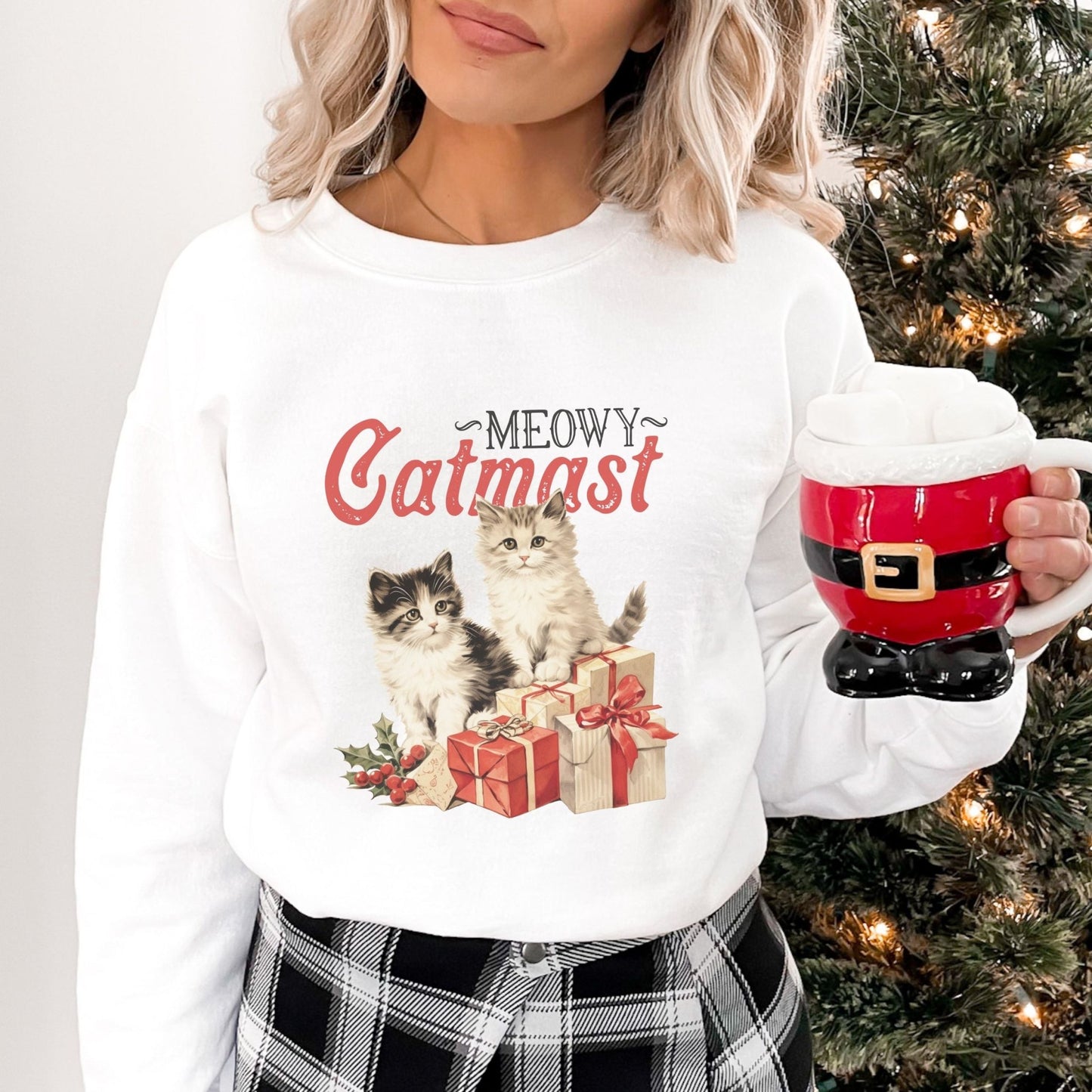 Christmas sweatshirt featuring "Meowy Catmas" with adorable cats and presents.