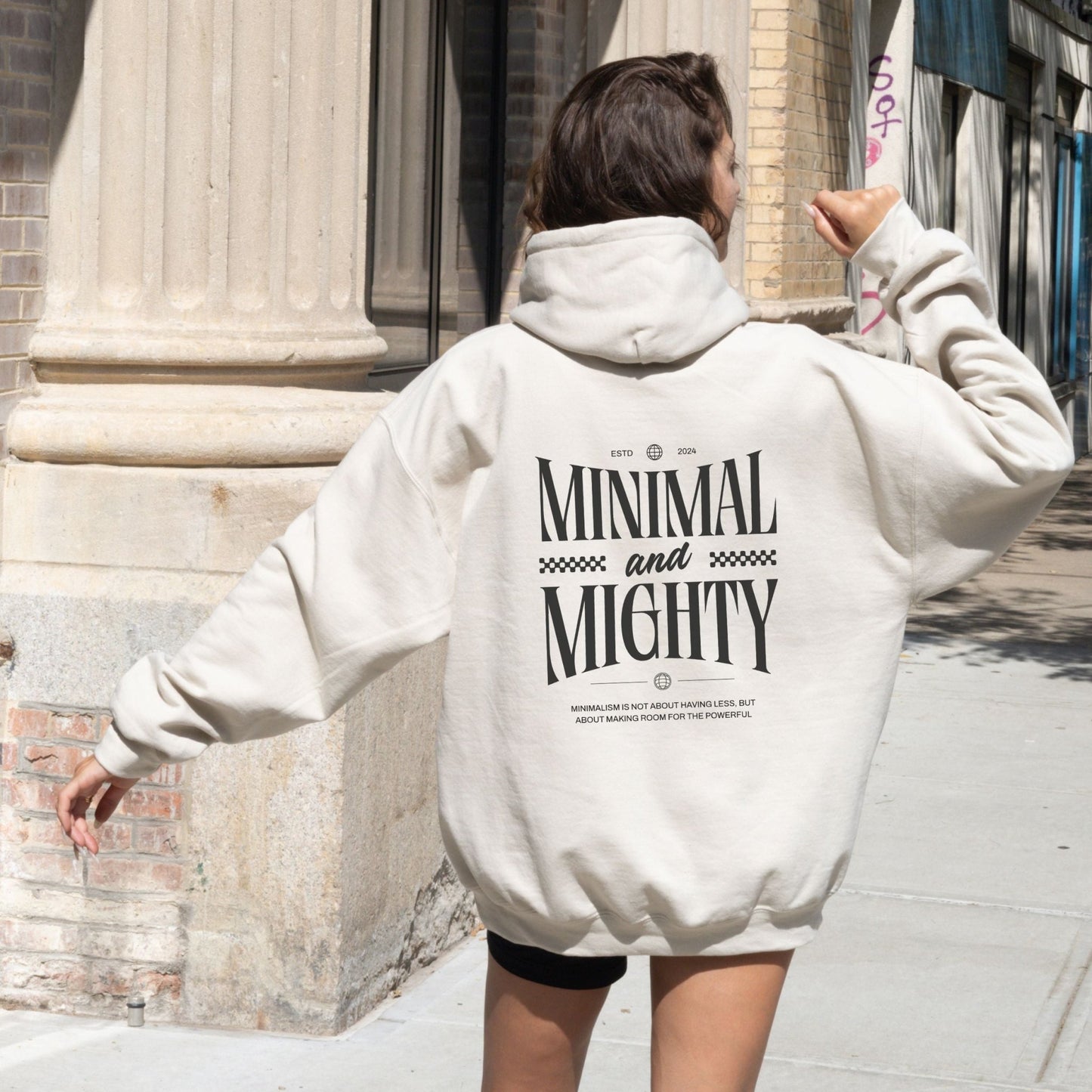 Minimal and Mighty hoodie with bold typography design.