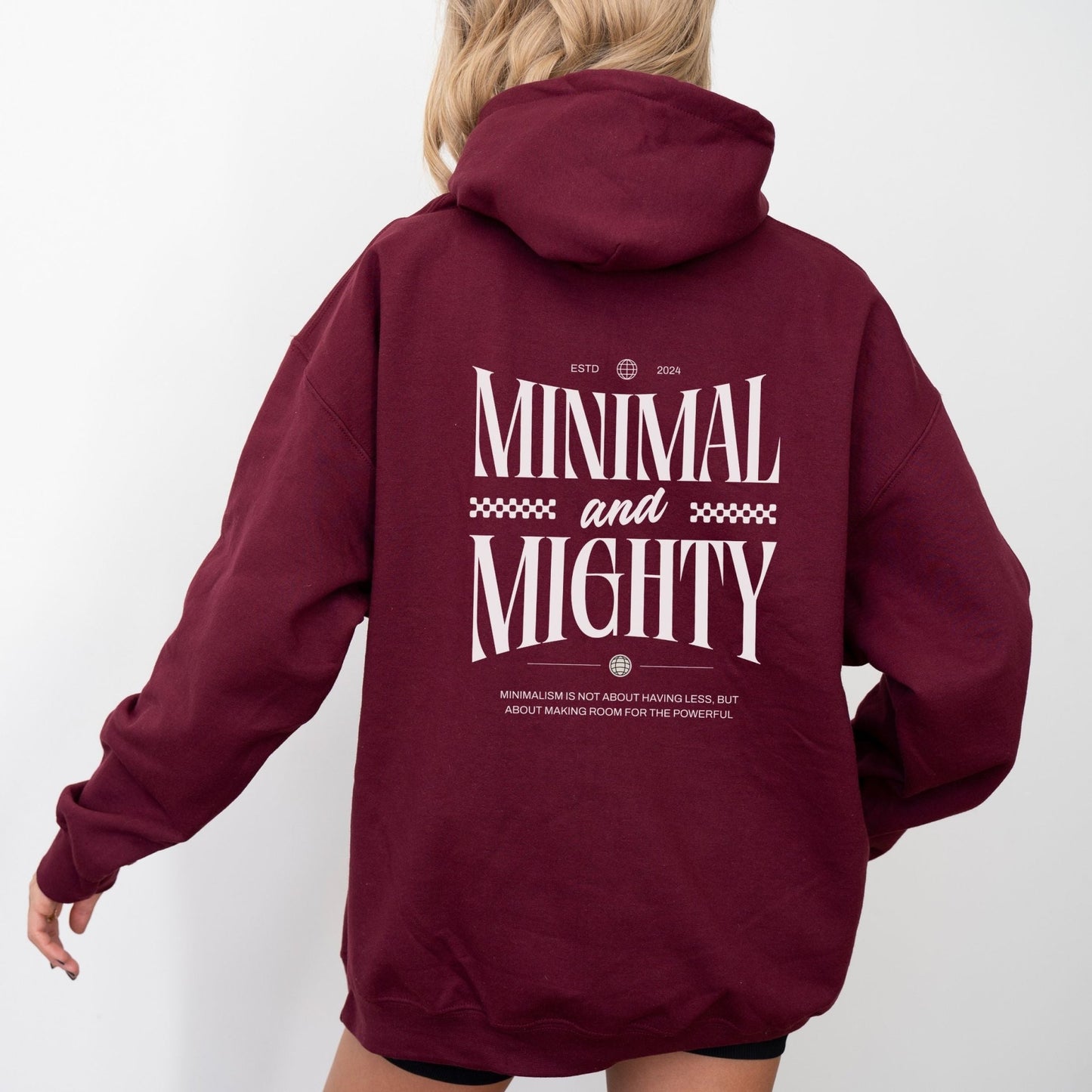 Minimal and Mighty hoodie with bold typography design.