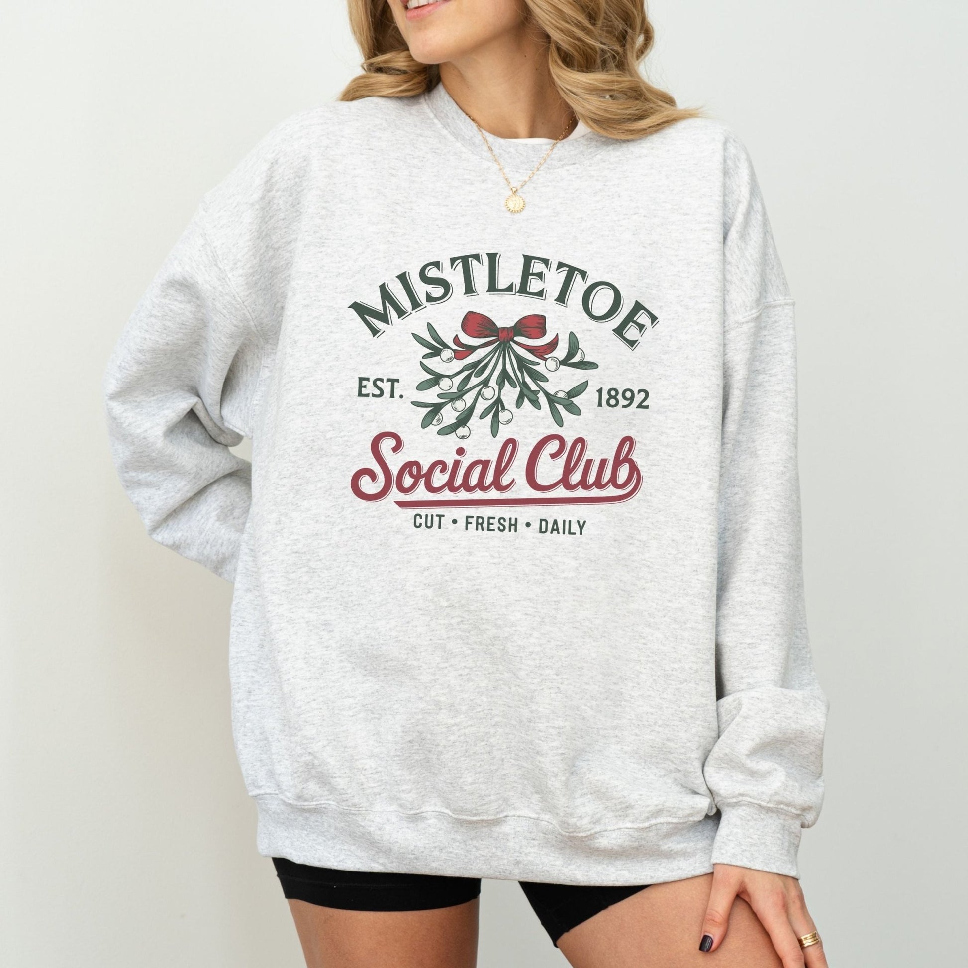 Mistletoe social club holiday sweatshirt with vintage Christmas design.