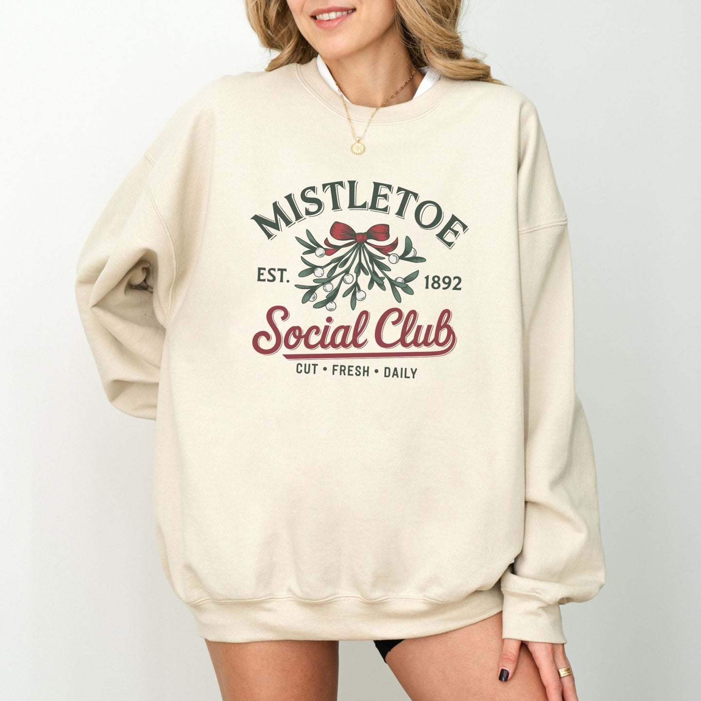 Mistletoe social club holiday sweatshirt with vintage Christmas design.