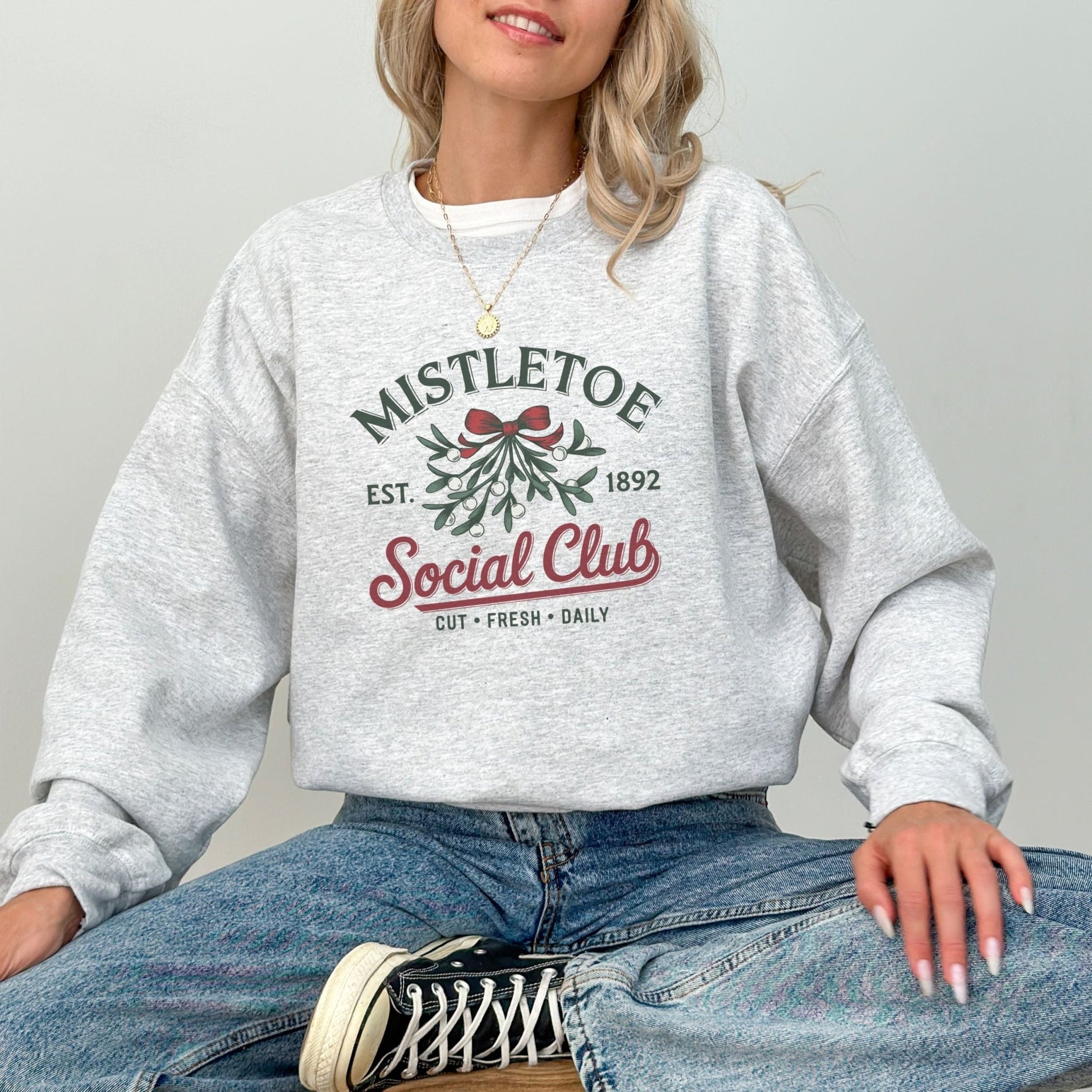 Mistletoe social club holiday sweatshirt with vintage Christmas design.