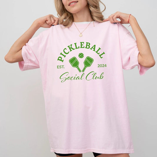 Pickleball Social Club t-shirt with paddles design, available in 7 colors, perfect for pickleball lovers.