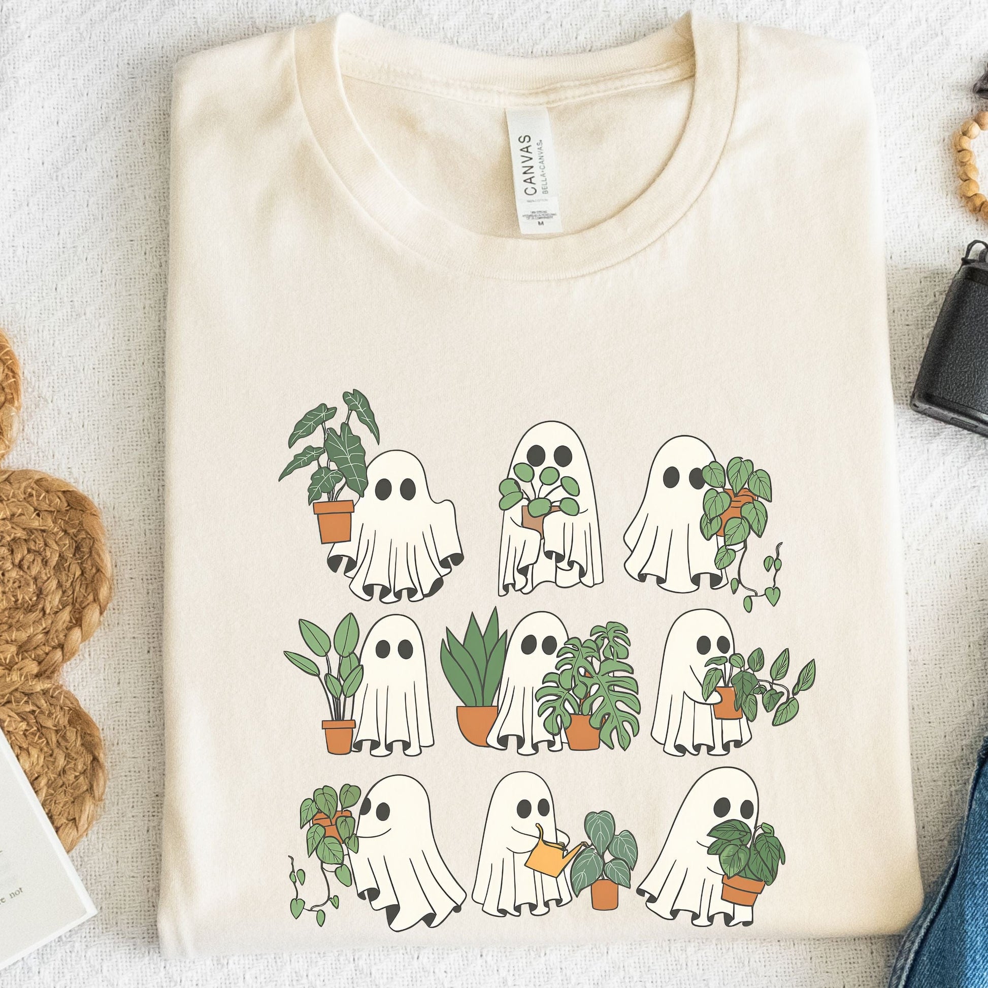 Natural t-shirt with ghost and plant design on a light background