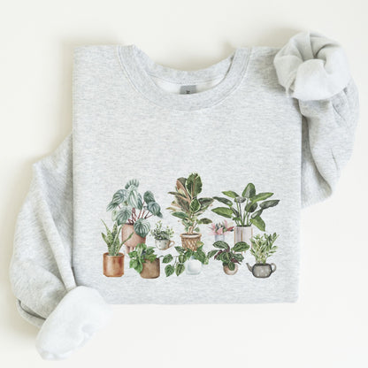 Cozy unisex sweatshirt featuring a watercolor-style houseplant graphic — perfect for plant lovers and indoor garden aesthetic fans.