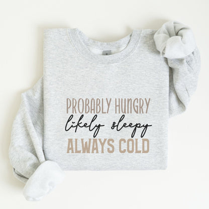 Funny “Probably Hungry, Always Cold” sweatshirt with neutral text on a cozy crewneck — perfect for comfort lovers and snack queens.