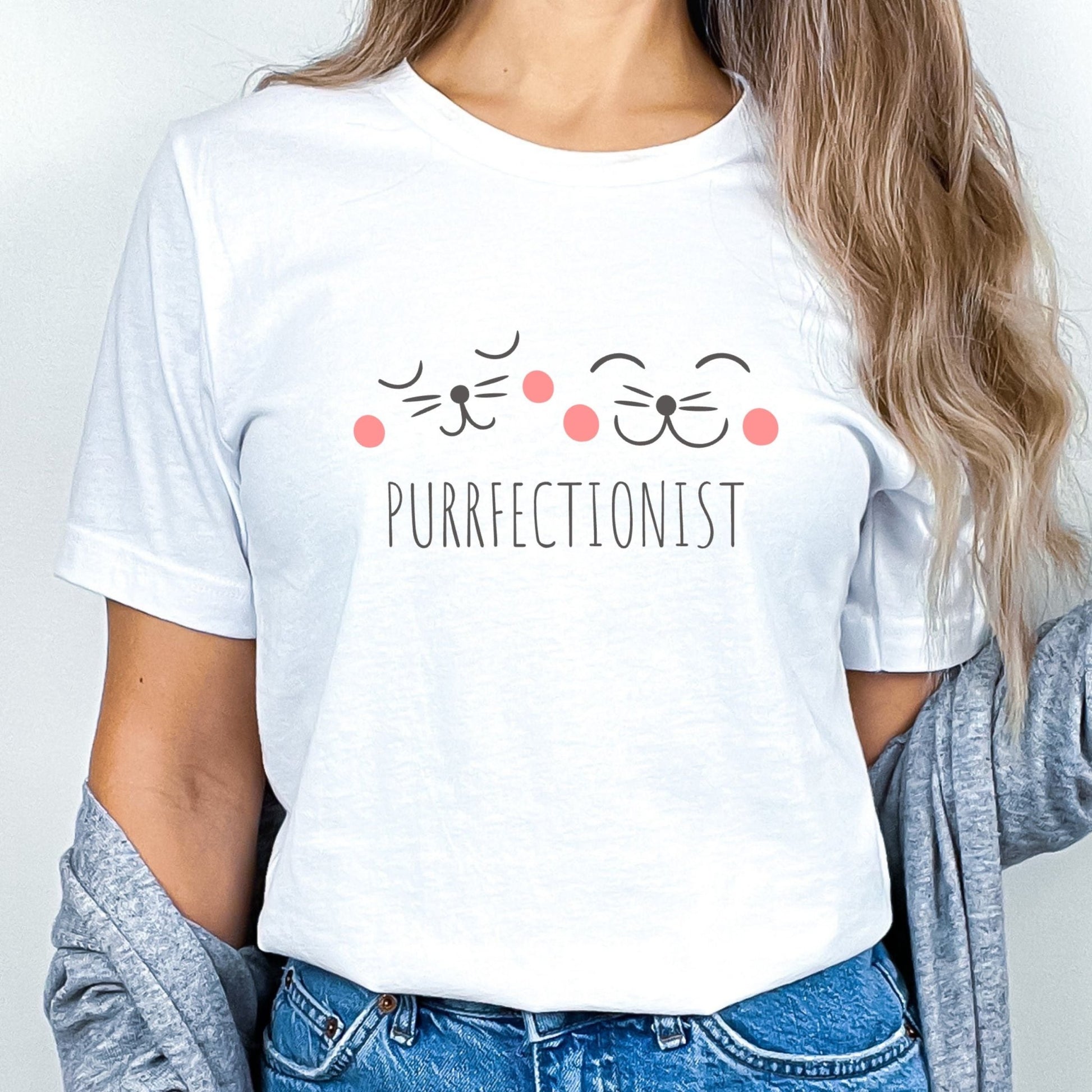 Shirt with "Purrfectionist" text and cute cat face design for cat lovers.