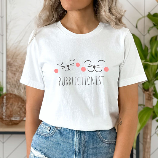 Shirt with "Purrfectionist" text and cute cat face design for cat lovers.