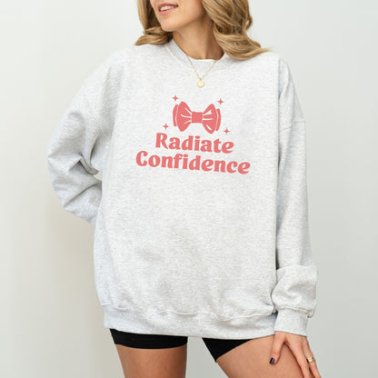 Radiate Confidence sweatshirt with a cute bow design in vibrant colors, empowering and cozy apparel.