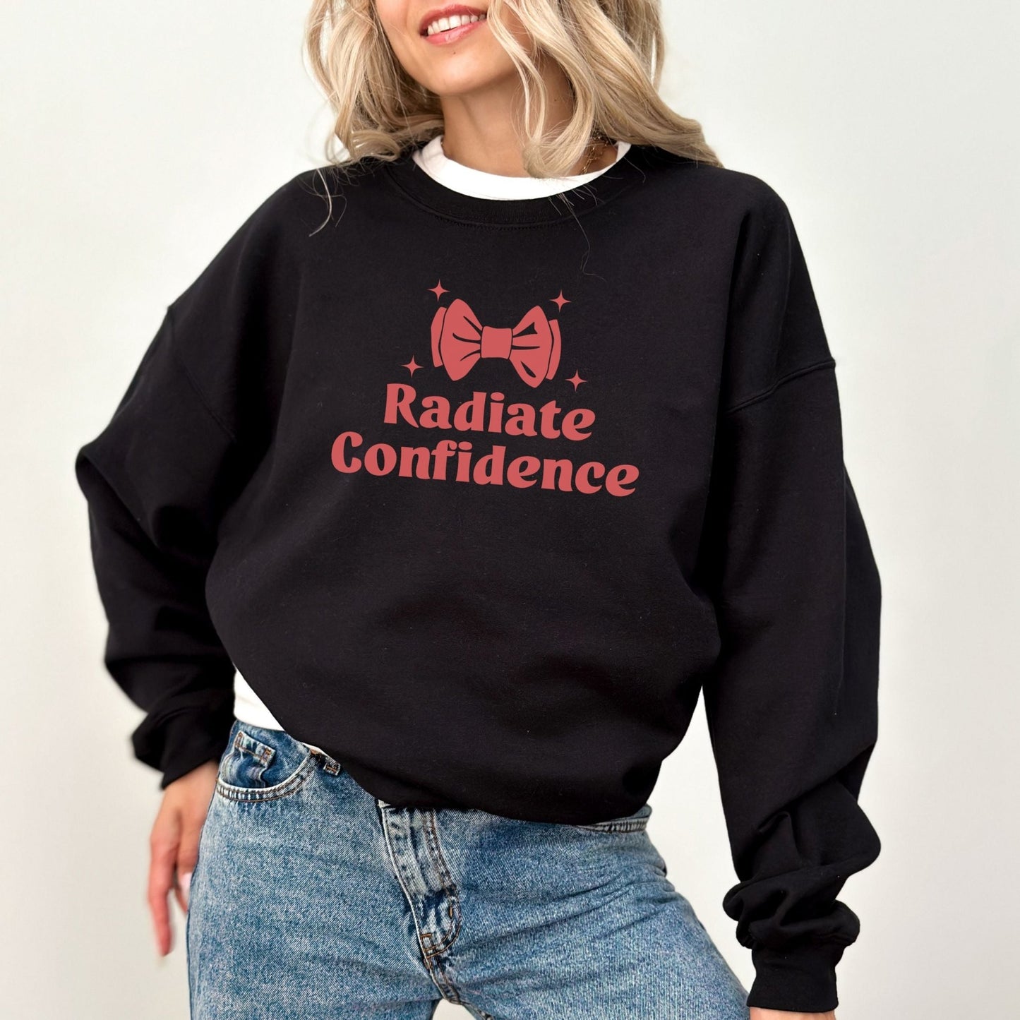 Radiate Confidence sweatshirt with a cute bow design in vibrant colors, empowering and cozy apparel.