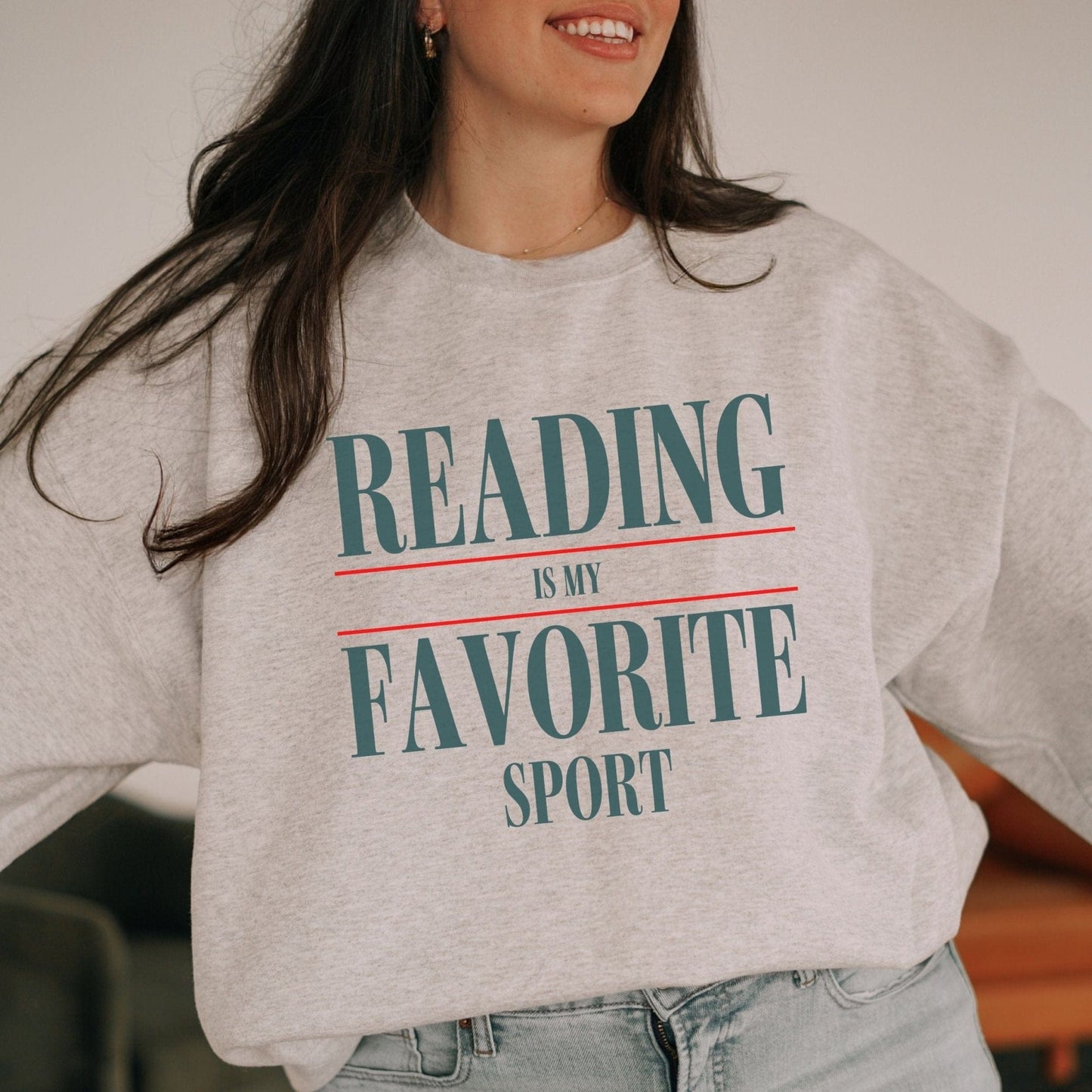 “Reading is My Favorite Sport” sweatshirt with bold varsity-style typography — cozy reader crewneck for book lovers and literary fans.