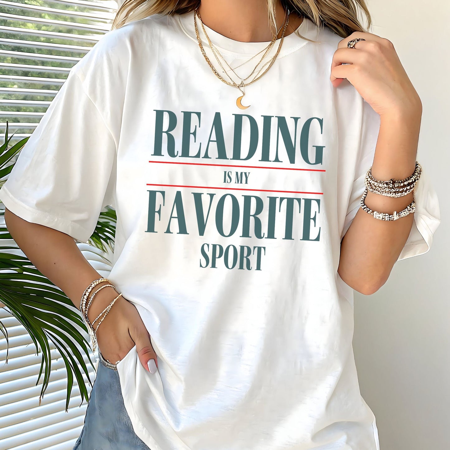 “Reading Is My Favorite Sport” t-shirt with bold serif font in dark teal and red underline accents, minimalist literary design.
