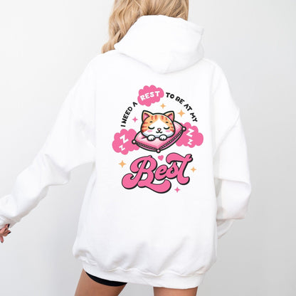 Kawaii hoodie with "Rest to Be at Your Best" back design featuring a cute cat sleeping on a pillow, and a matching mini cat graphic on the front chest.