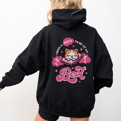 Kawaii hoodie with "Rest to Be at Your Best" back design featuring a cute cat sleeping on a pillow, and a matching mini cat graphic on the front chest.
