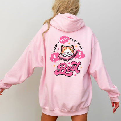 Kawaii hoodie with "Rest to Be at Your Best" back design featuring a cute cat sleeping on a pillow, and a matching mini cat graphic on the front chest.