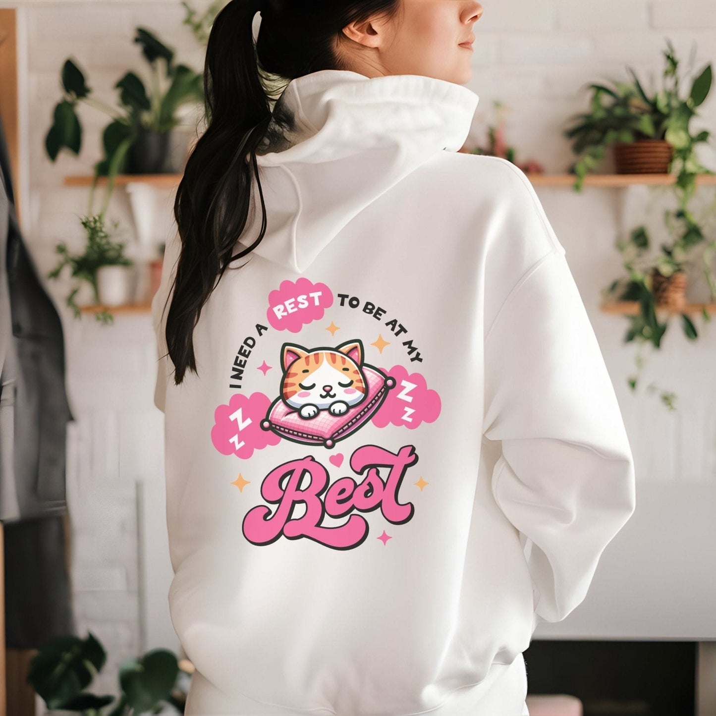 Kawaii hoodie with "Rest to Be at Your Best" back design featuring a cute cat sleeping on a pillow, and a matching mini cat graphic on the front chest.