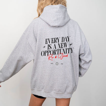 Rise & Grind motivational hoodie with minimalist typography design for daily inspiration.