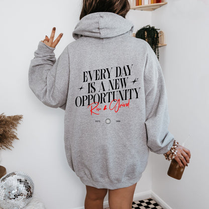 Rise & Grind motivational hoodie with minimalist typography design for daily inspiration.