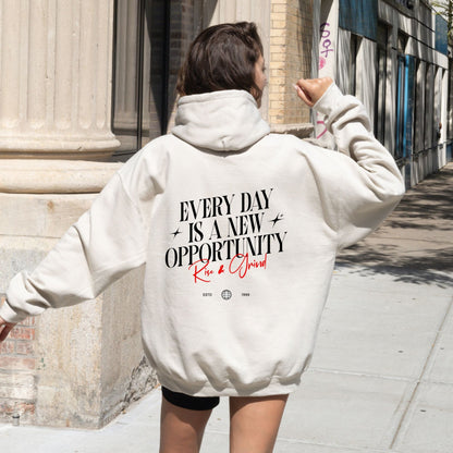 Rise & Grind motivational hoodie with minimalist typography design for daily inspiration.