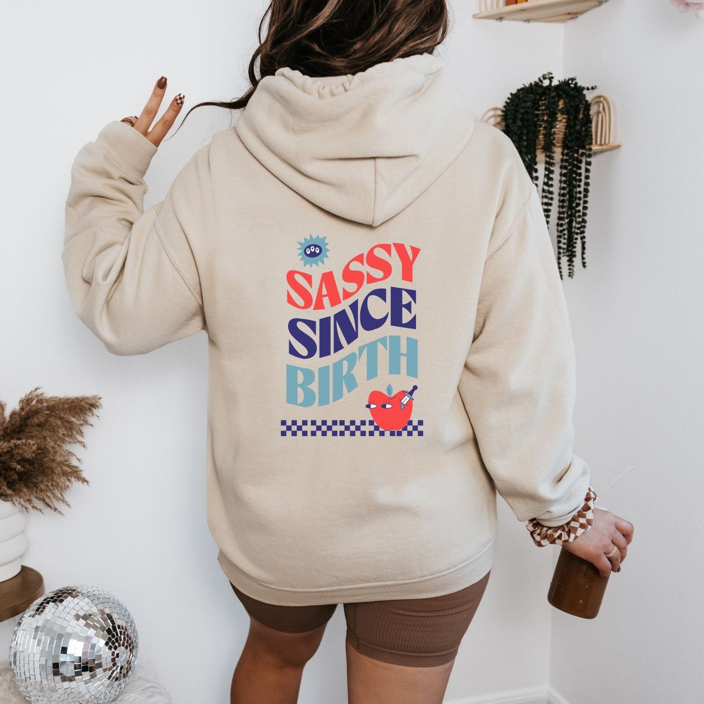 Sassy Since Birth hoodie with bold typography and colorful graphic design, cozy and available in 6 colors.