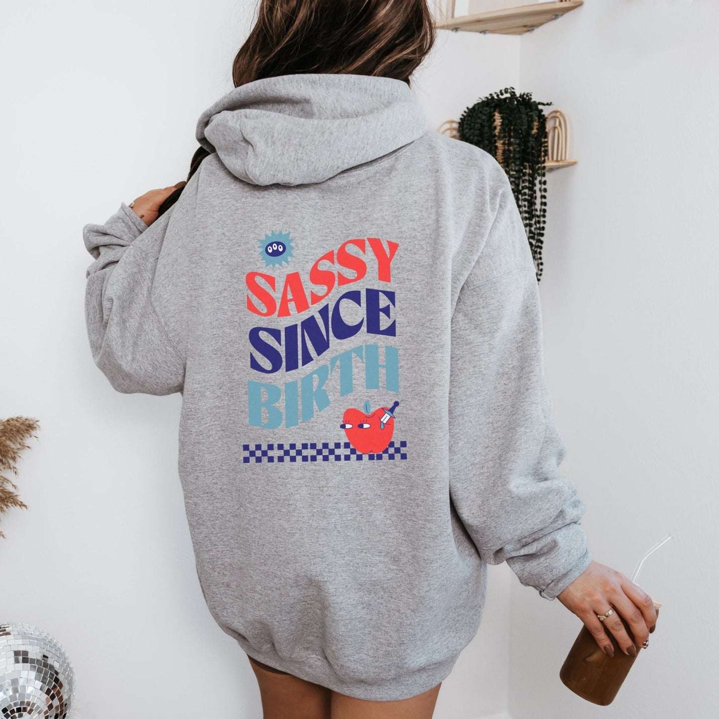 Sassy Since Birth hoodie with bold typography and colorful graphic design, cozy and available in 6 colors.