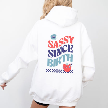 Sassy Since Birth hoodie with bold typography and colorful graphic design, cozy and available in 6 colors.