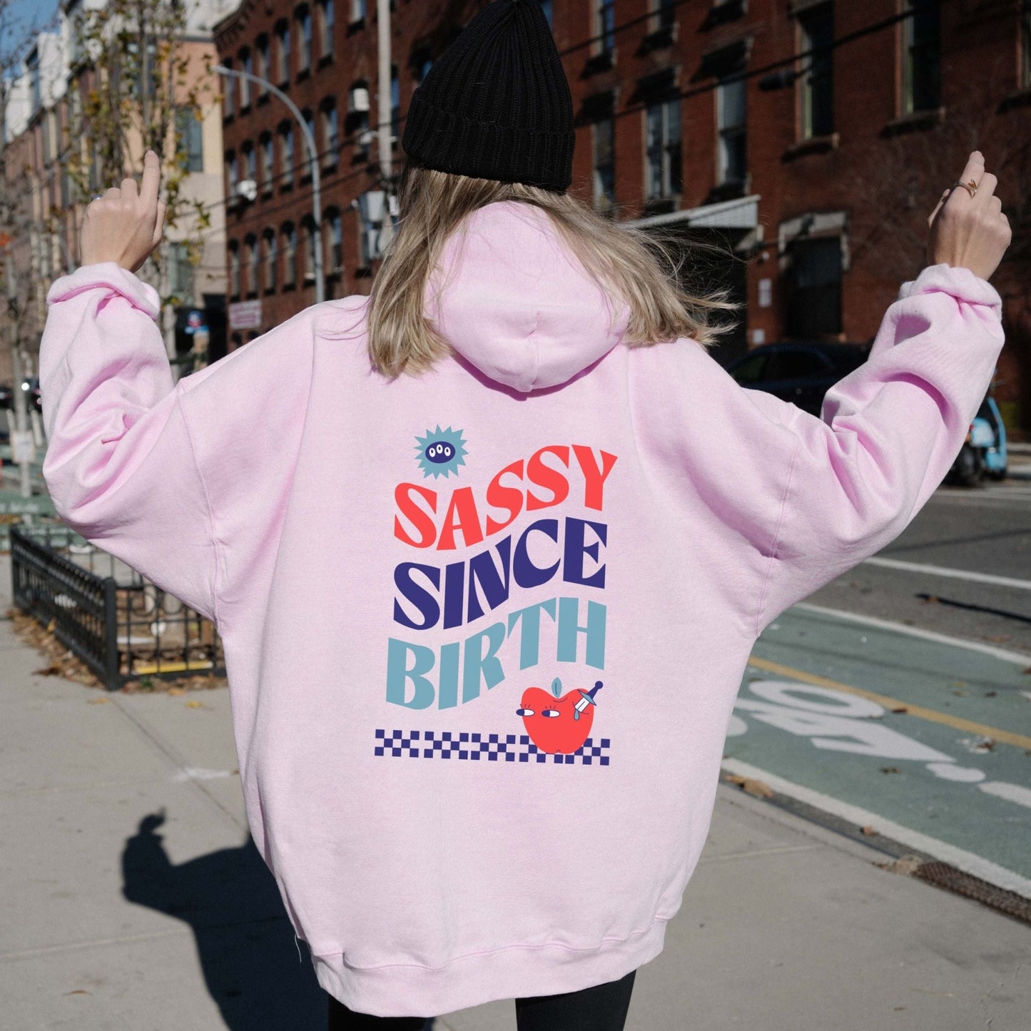 Sassy Since Birth hoodie with bold typography and colorful graphic design, cozy and available in 6 colors.