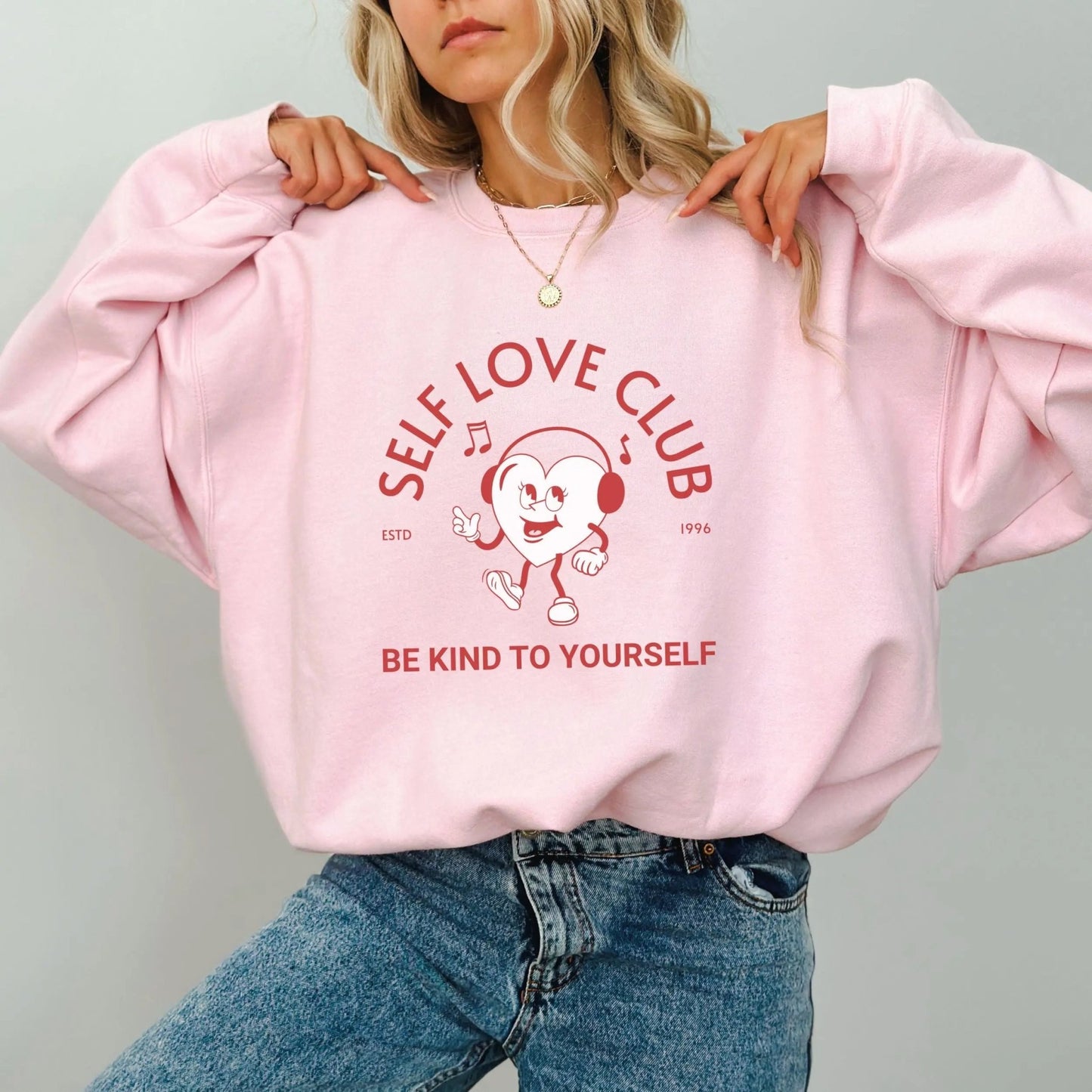 Self Love Club sweatshirt, vintage-inspired design, Y2K streetwear, cheerful heart character.