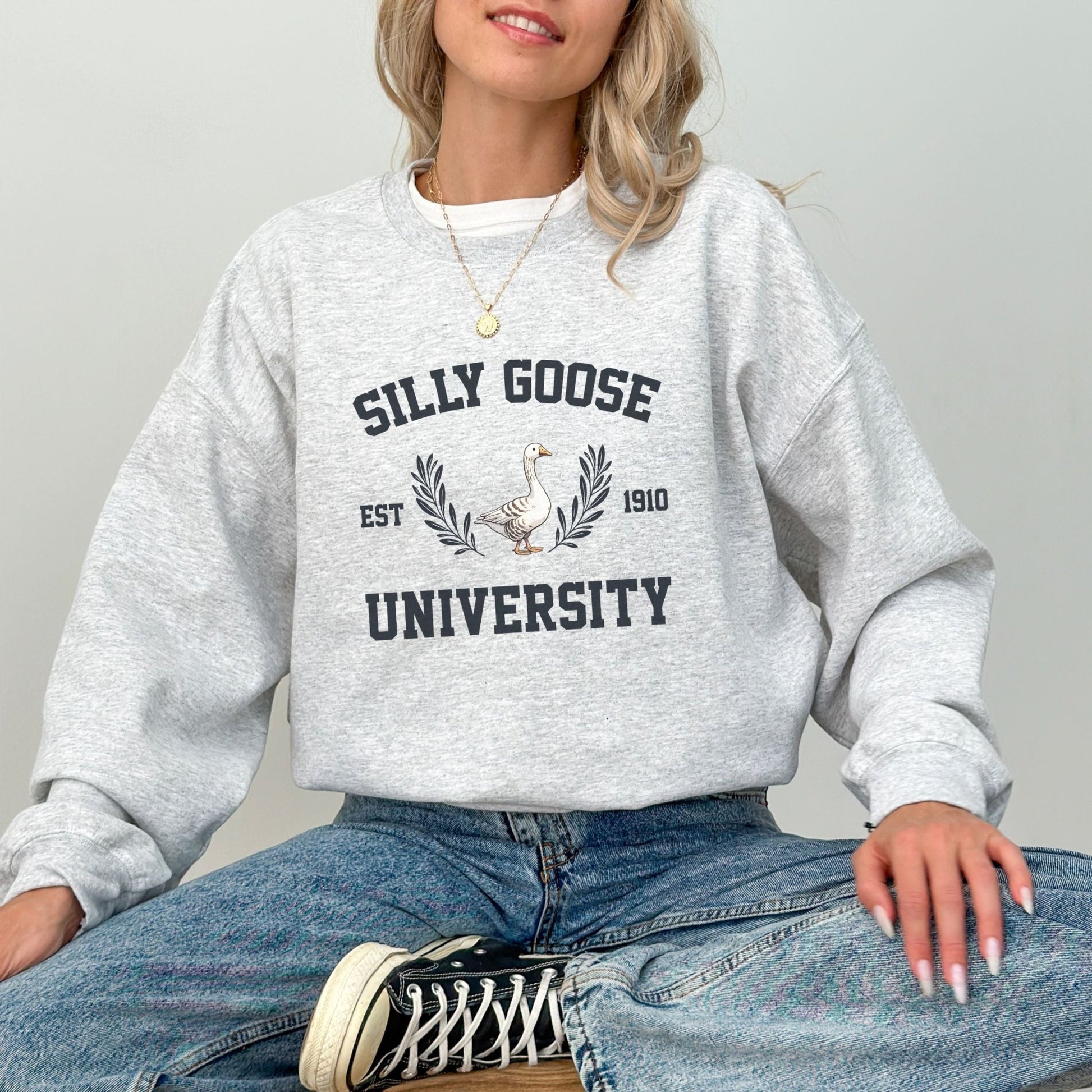 "Silly Goose University" funny graphic sweatshirt, 50% cotton, 50% polyester, available in 9 colors.