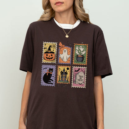 Vintage Halloween t-shirt with postage stamp illustrations of ghosts, pumpkins, black cat, haunted house, and trick-or-treat