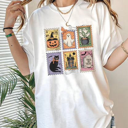 Vintage Halloween t-shirt with postage stamp illustrations of ghosts, pumpkins, black cat, haunted house, and trick-or-treat
