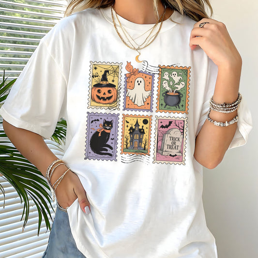 Vintage Halloween t-shirt with postage stamp illustrations of ghosts, pumpkins, black cat, haunted house, and trick-or-treat