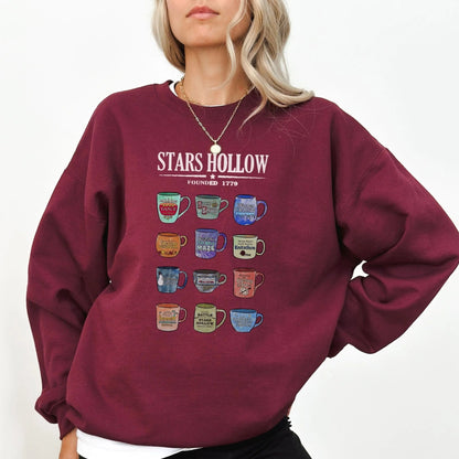 "Stars Hollow Mugs" sweatshirt, cozy town aesthetic, Gilmore Girls merch, 9 colors.