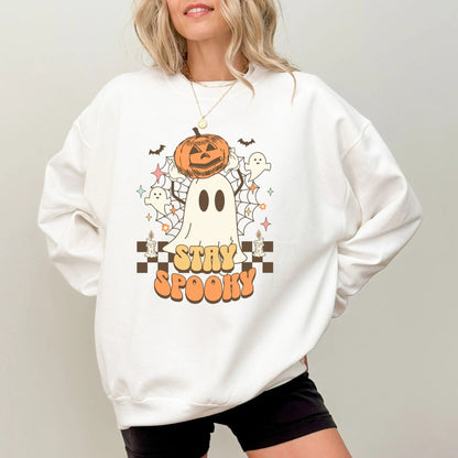 Retro "Stay Spooky" sweatshirt with ghost and pumpkin design, available in 10 colors.