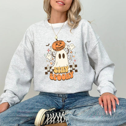 Retro "Stay Spooky" sweatshirt with ghost and pumpkin design, available in 10 colors.