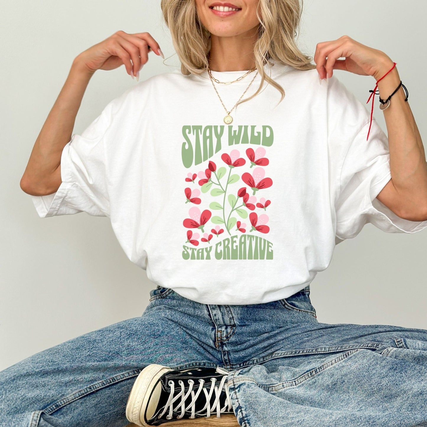 Stay Wild t-shirt with retro floral design and inspirational quote for creatives.