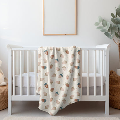 Pastel strawberry baby blanket with whimsical berry design, ideal for cozy nursery decor.