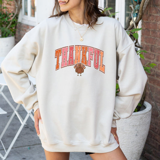 Thanksgiving sweatshirt with a "Thankful" text and turkey graphic design.