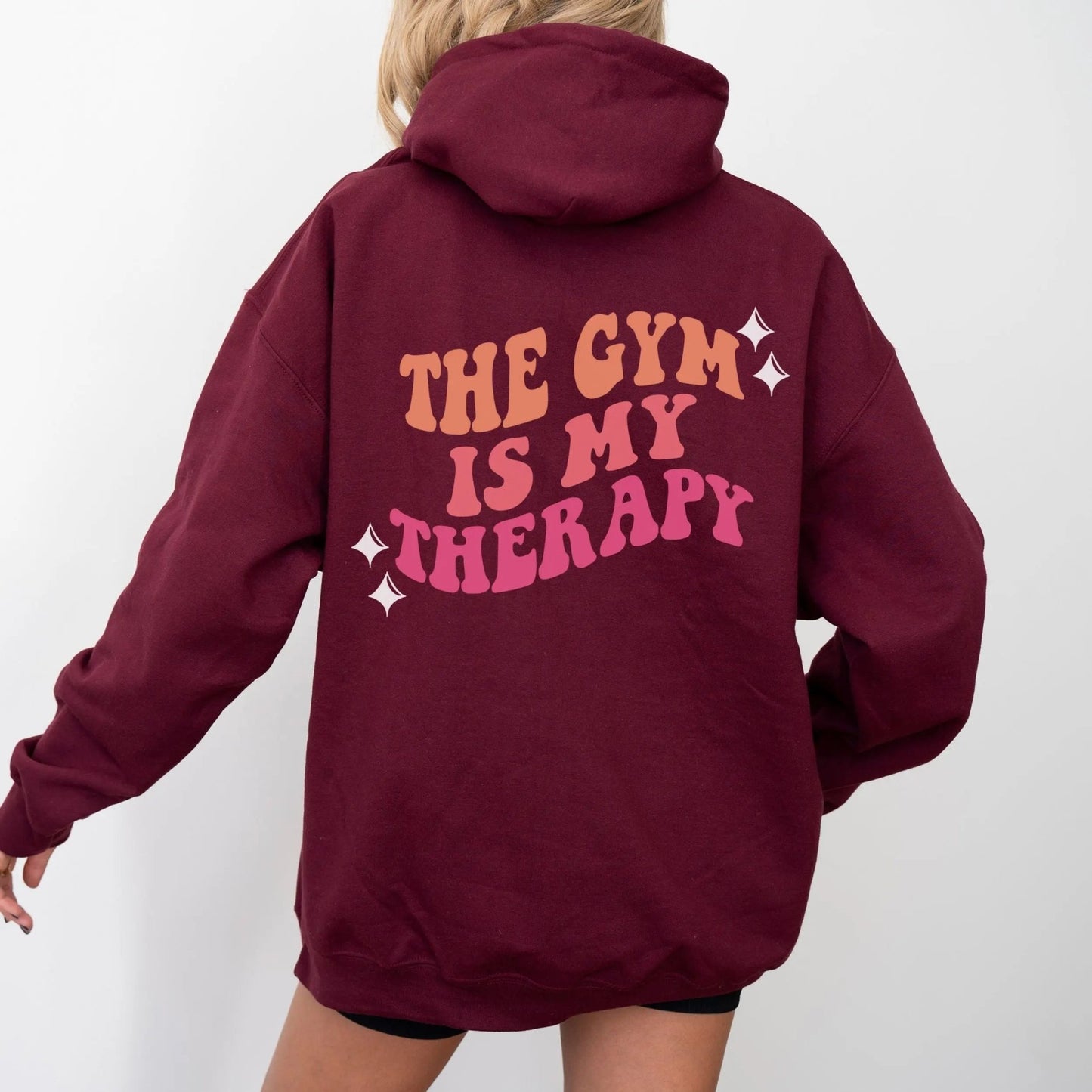 "The Gym is My Therapy" hoodie from That Cozy Vibe, available in 10 colors, fitness motivation.