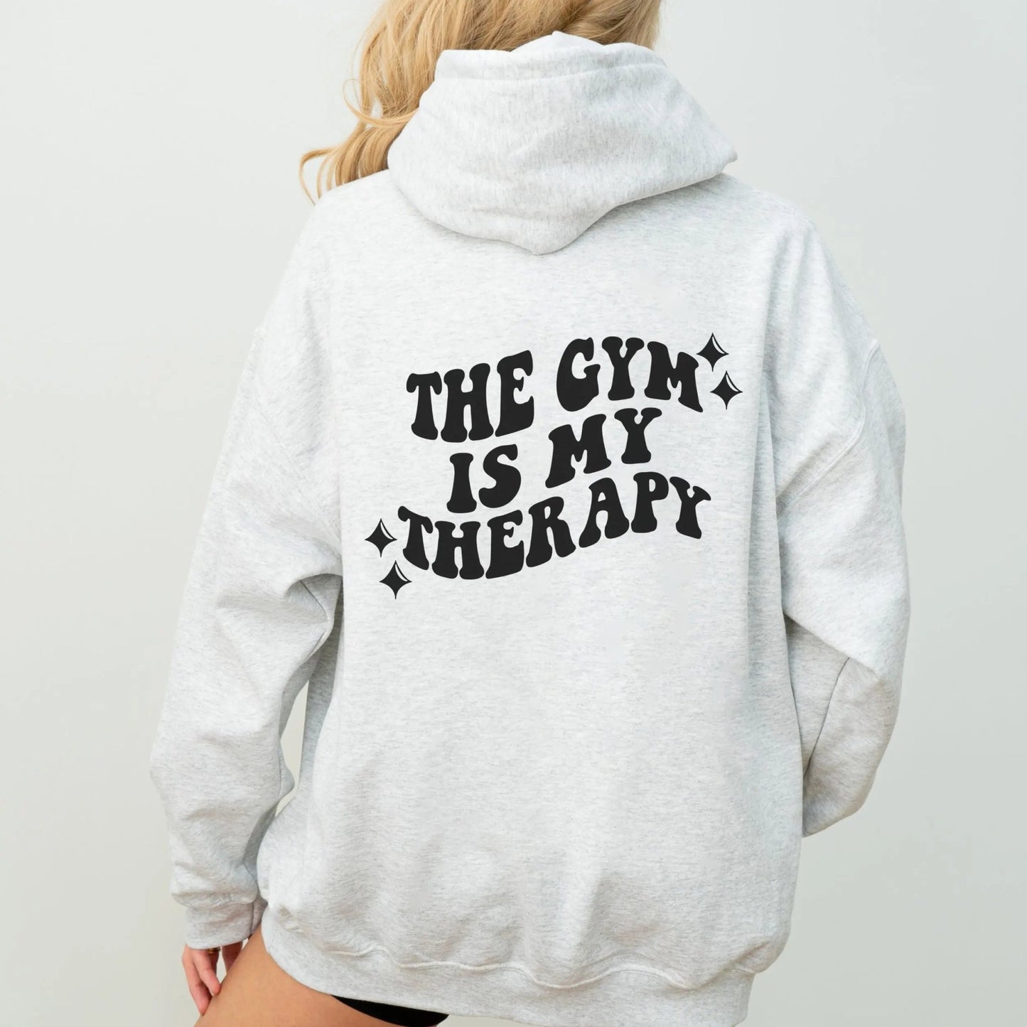 "The Gym is My Therapy" hoodie from That Cozy Vibe, available in 10 colors, fitness motivation.