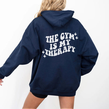 "The Gym is My Therapy" hoodie from That Cozy Vibe, available in 10 colors, fitness motivation.